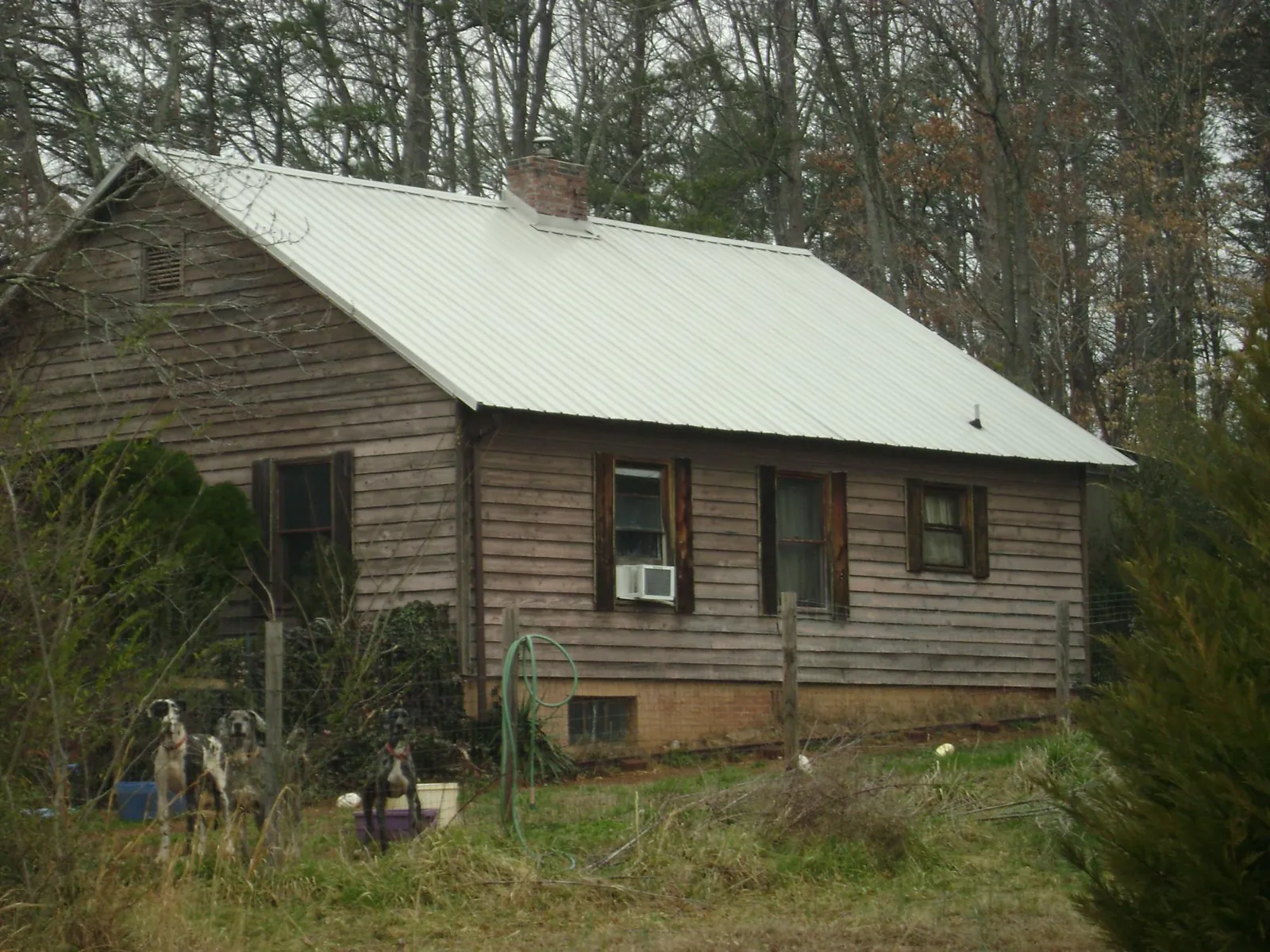 White metal roof on an old wood sided farmhouse, from a Metal Roof Installation job in Turbeville